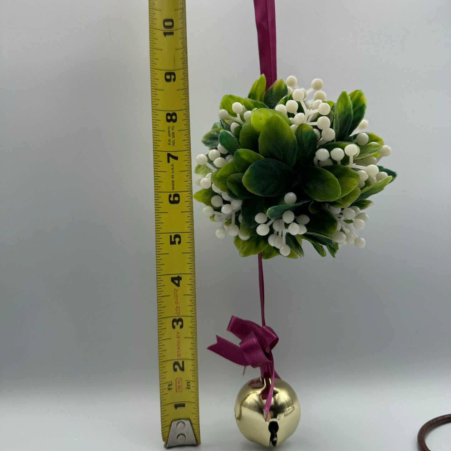 Hanging Christmas Mistletoe With Purple Ribbon And Jingle Bell