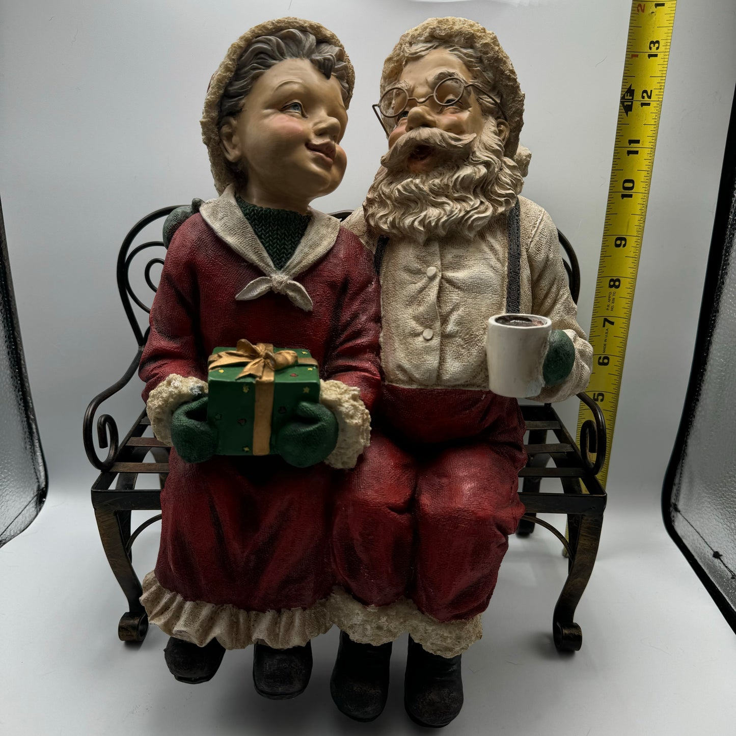 Resin Santa and Mrs. Claus Sitting On Metal Bench