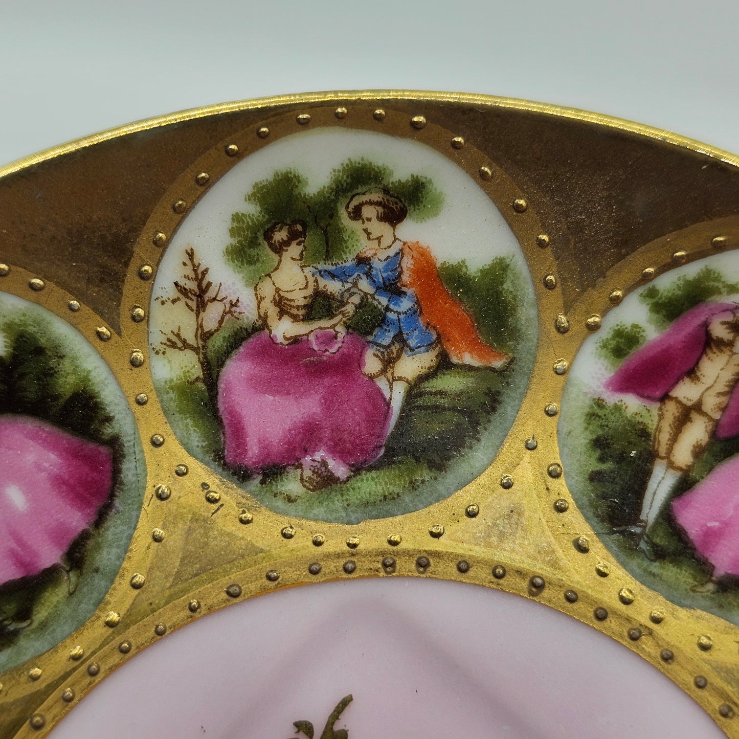 Vintage Royal Vienna Style Porcelain Saucer Featuring a Fragonard-Style Courting Couple Design, Square Cup Indent and Extensive Gold Gilt Trim