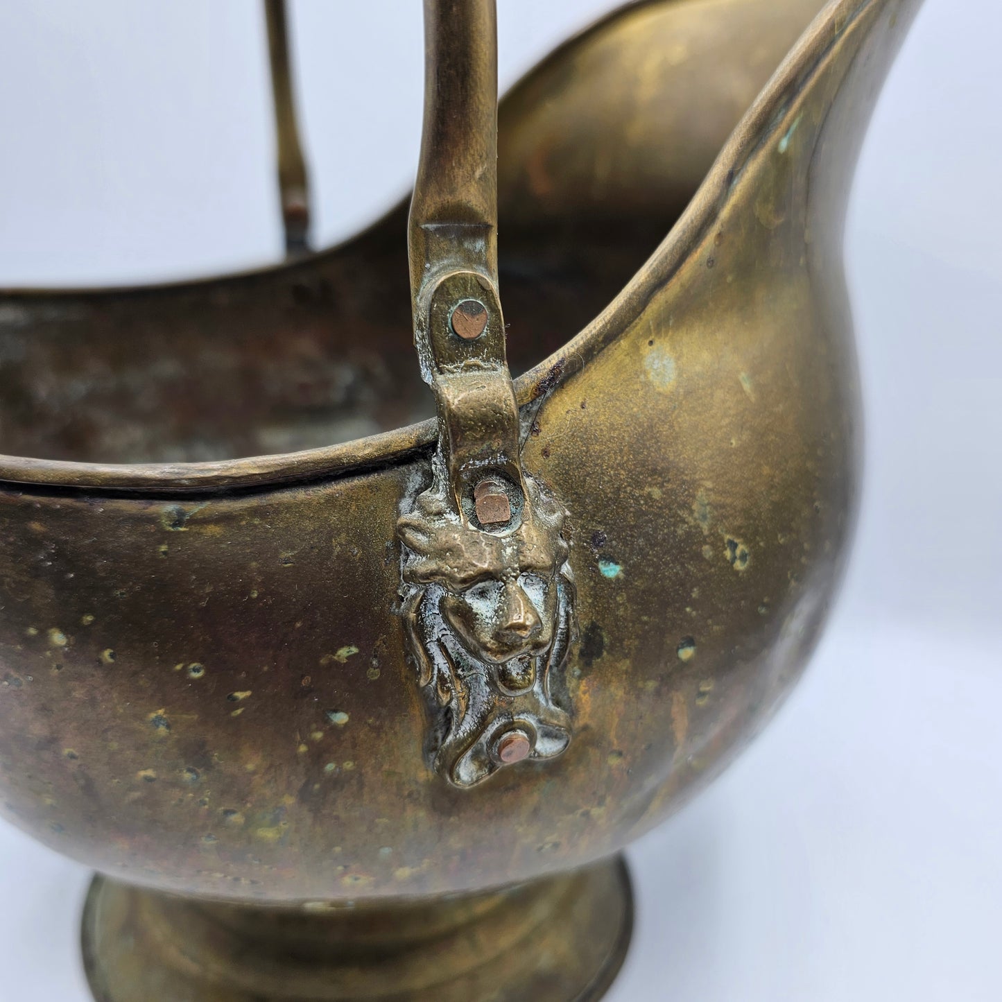 Vintage Brass Fireplace Coal Scuttle with a Blue and White Ceramic Handle and Lion Heads Securing the Handle