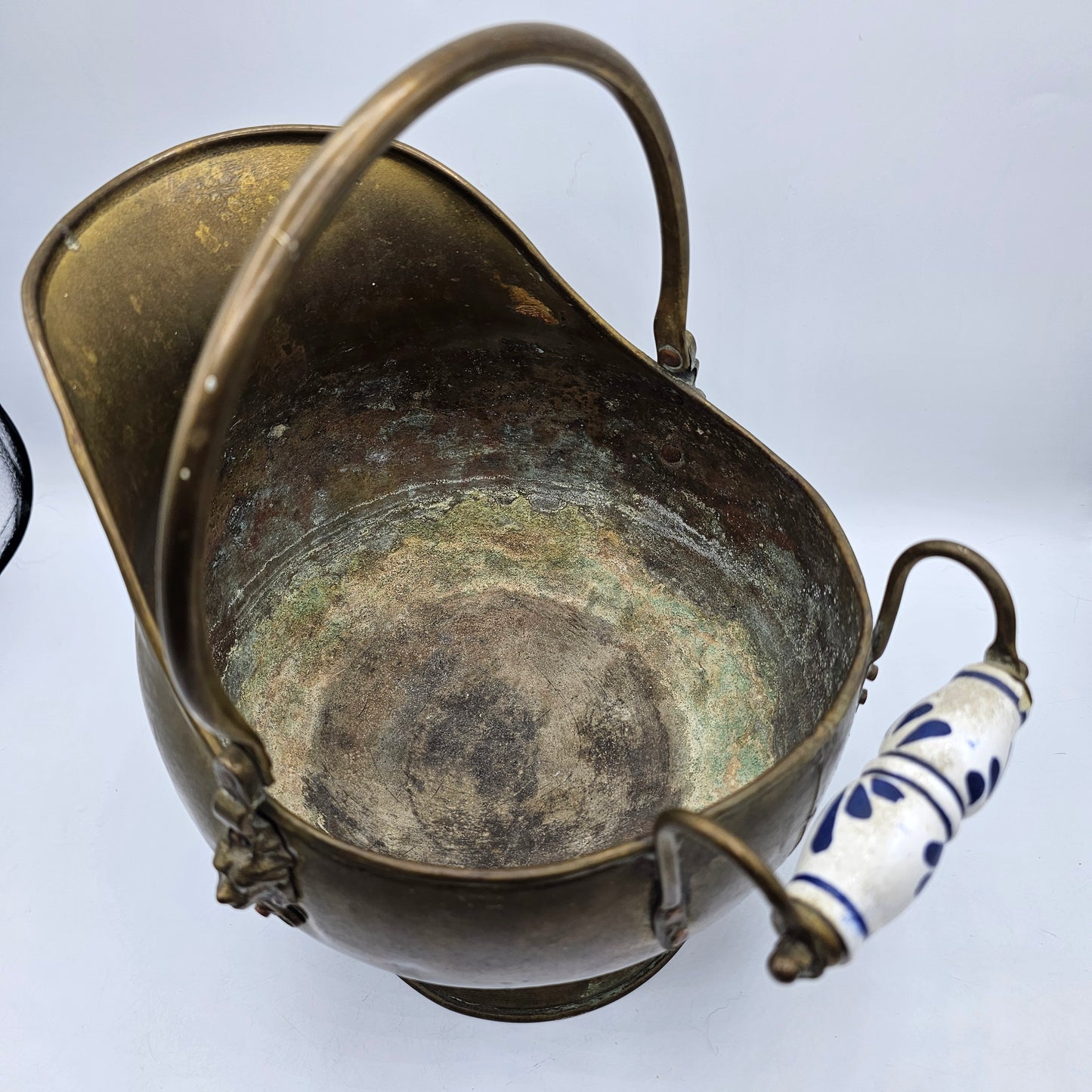 Vintage Brass Fireplace Coal Scuttle with a Blue and White Ceramic Handle and Lion Heads Securing the Handle
