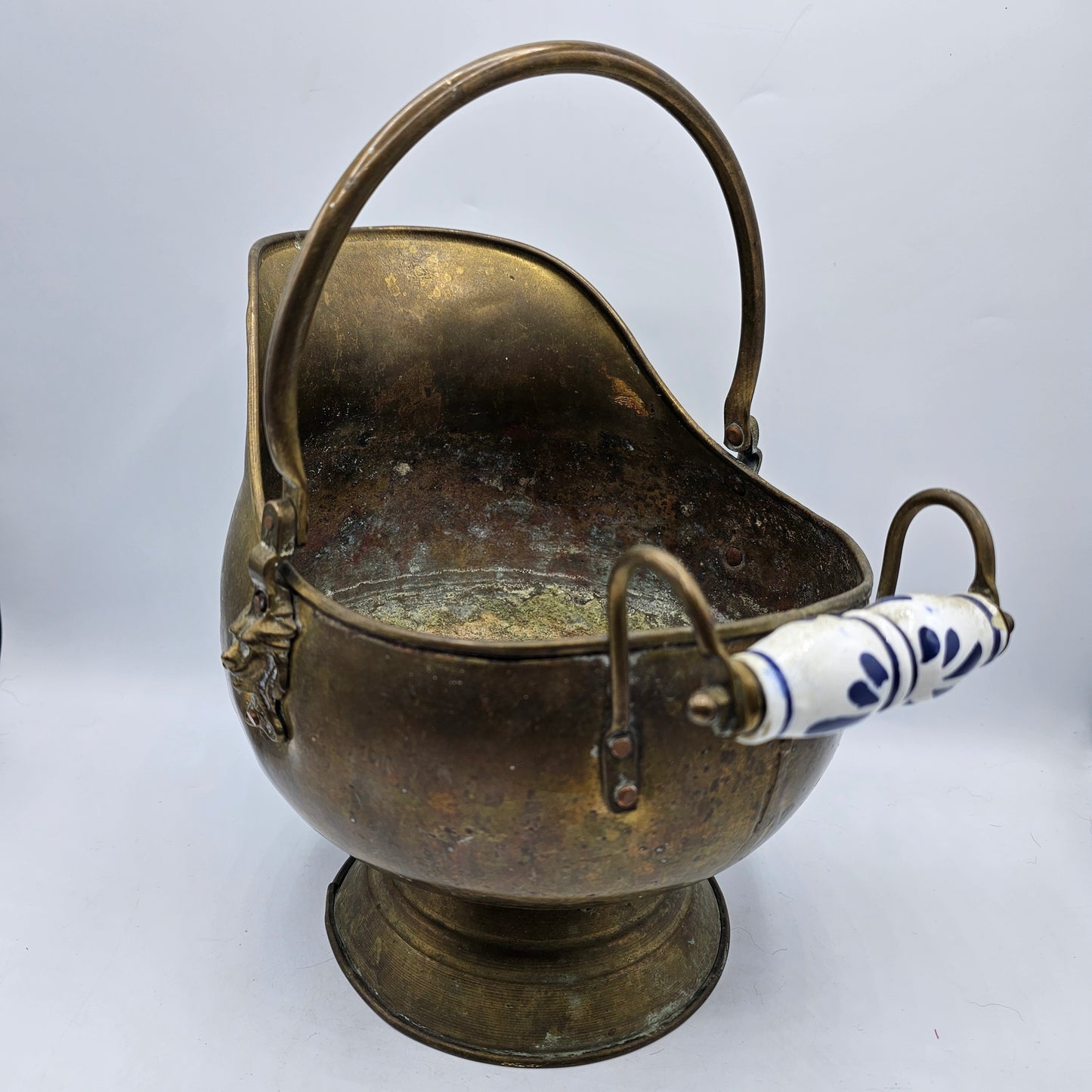 Vintage Brass Fireplace Coal Scuttle with a Blue and White Ceramic Handle and Lion Heads Securing the Handle