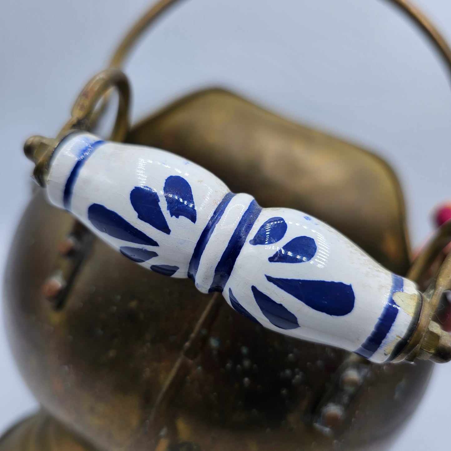 Vintage Brass Fireplace Coal Scuttle with a Blue and White Ceramic Handle and Lion Heads Securing the Handle