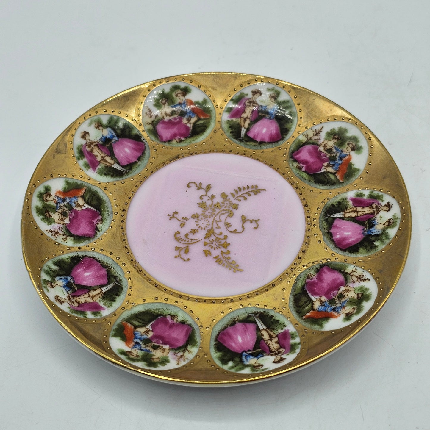 Vintage Royal Vienna Style Porcelain Saucer Featuring a Fragonard-Style Courting Couple Design, Square Cup Indent and Extensive Gold Gilt Trim