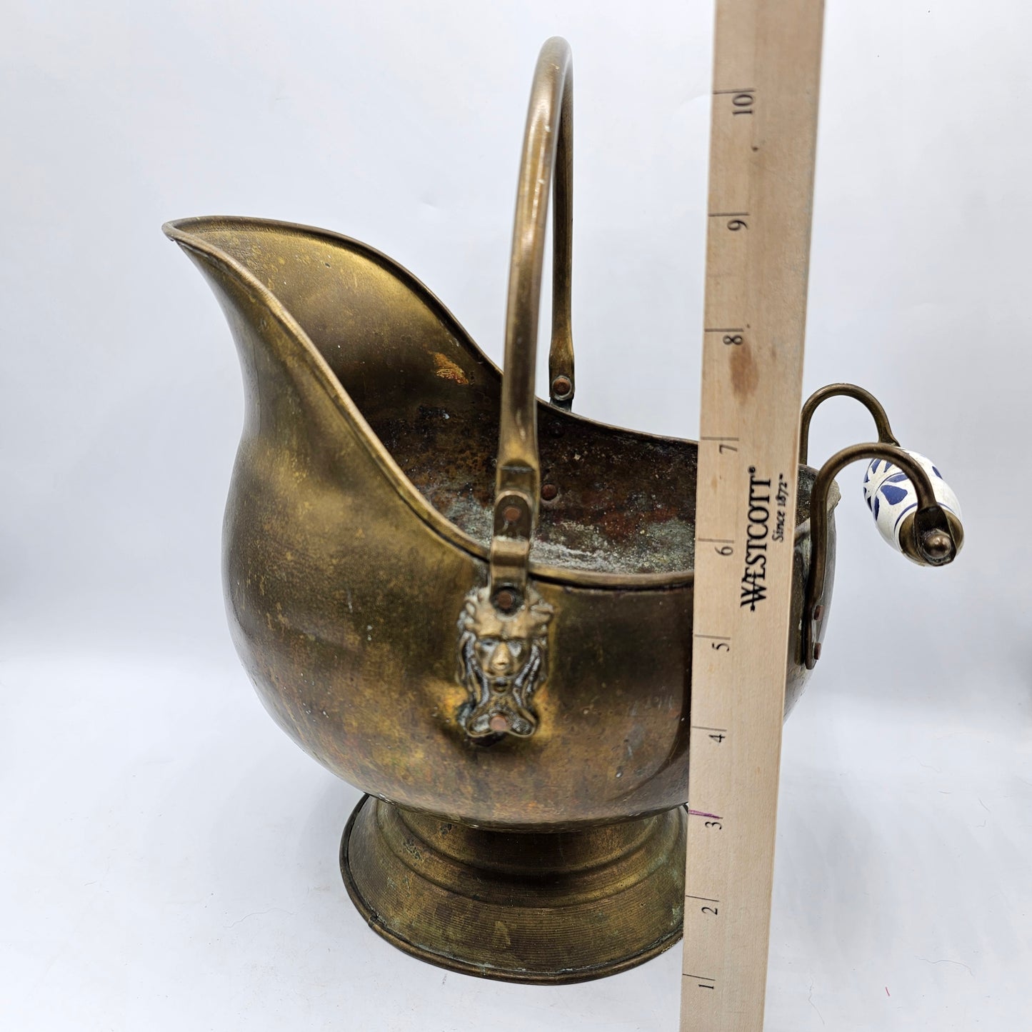 Vintage Brass Fireplace Coal Scuttle with a Blue and White Ceramic Handle and Lion Heads Securing the Handle