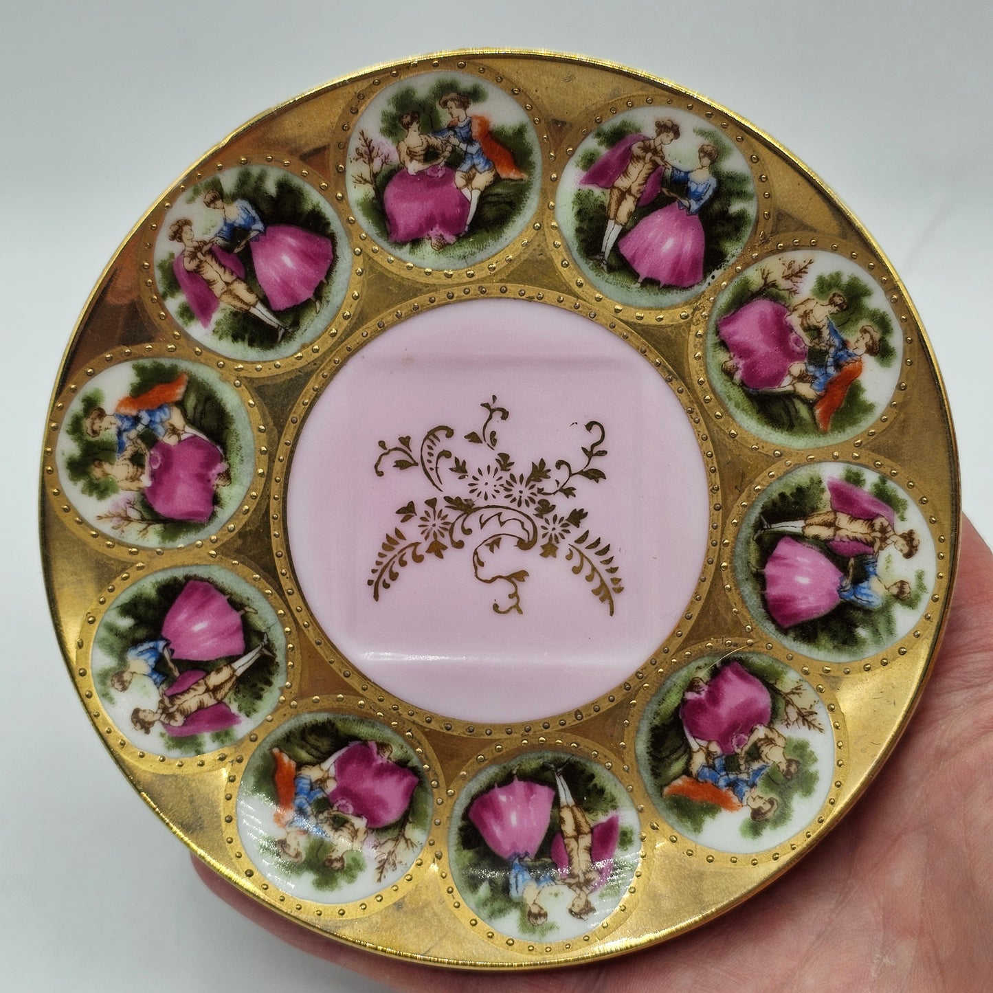Vintage Royal Vienna Style Porcelain Saucer Featuring a Fragonard-Style Courting Couple Design, Square Cup Indent and Extensive Gold Gilt Trim