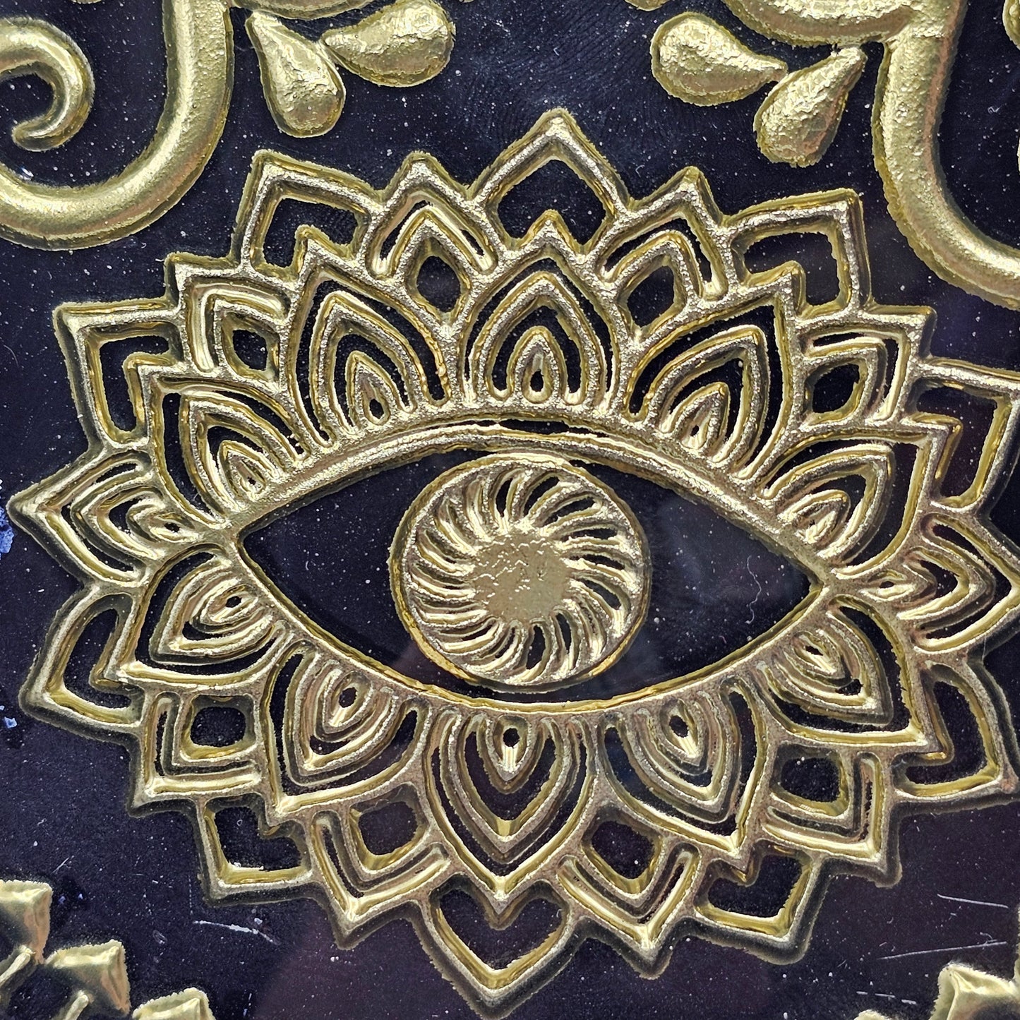 Hamsa hand trinket dish with black glaze, intricate gold-toned evil eye and mandala detailing