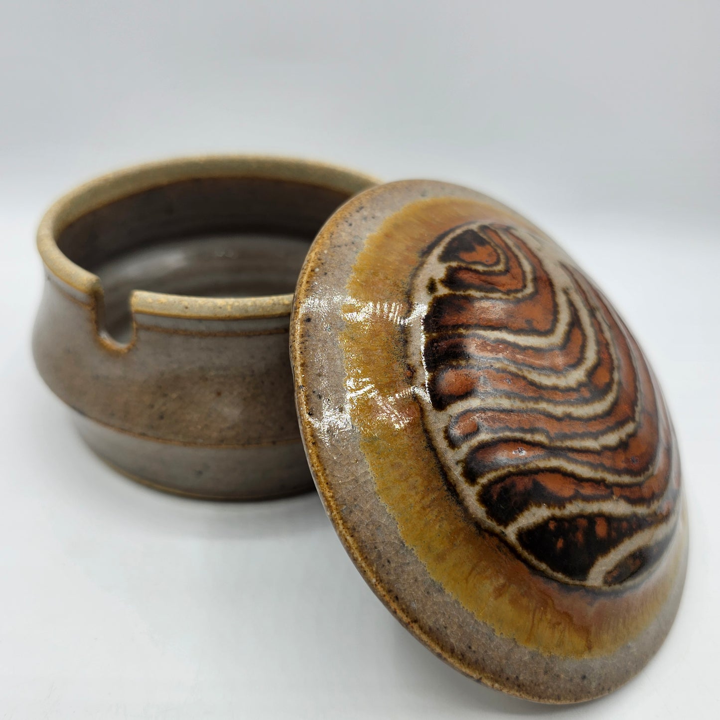 Art Pottery Lidded Jelly Jar or Honey Pot with Swirl Design and Spoon Cutout